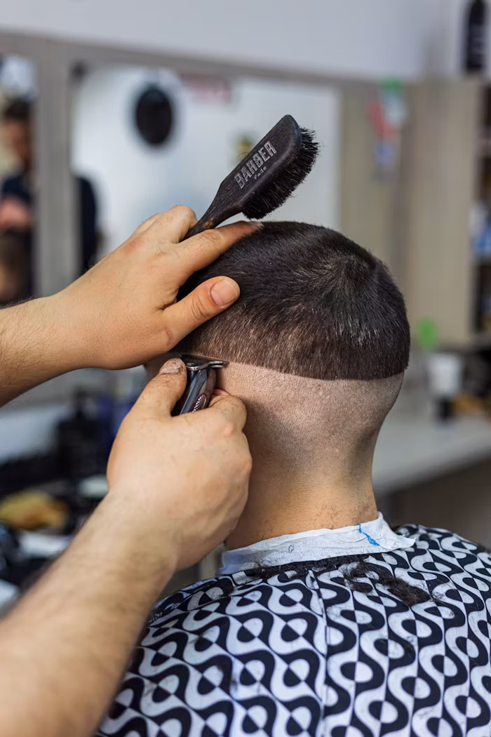 A man having a haircut with a barber